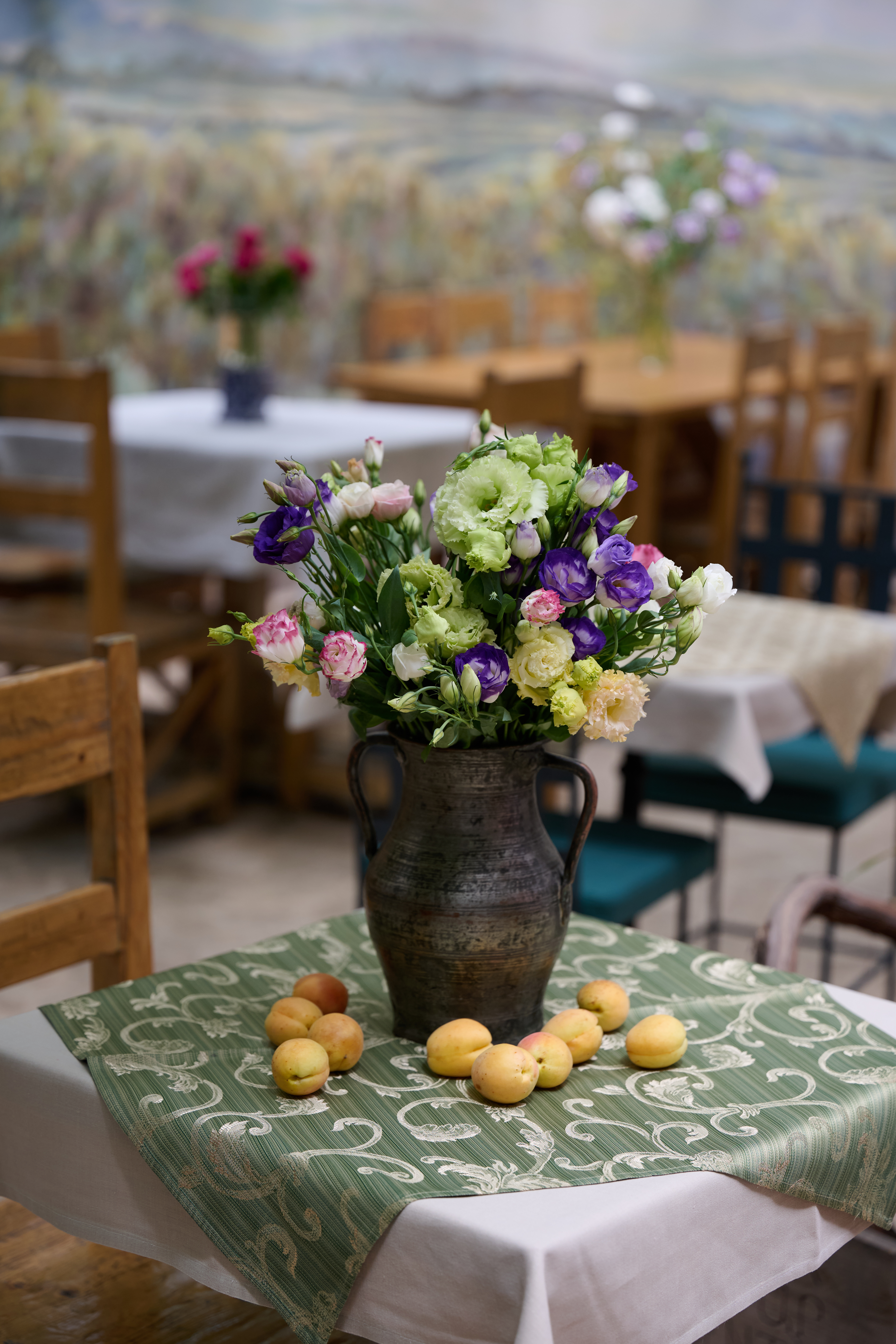 Fresh flowers on a Dolmama dining table in the warm restaurant room