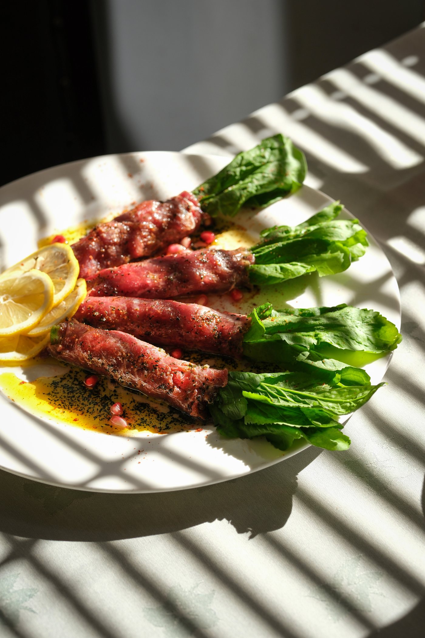 Grilled beef wrapped in herbs with lemon